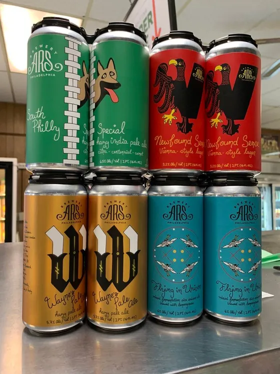 Four-packs of Brewery ARS beer stacked on the counter